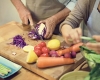 two people cutting vegetables